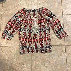 Tan, black, white, and red patterned blouse
